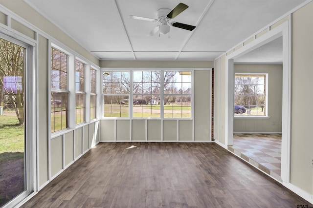 unfurnished sunroom featuring a ceiling fan