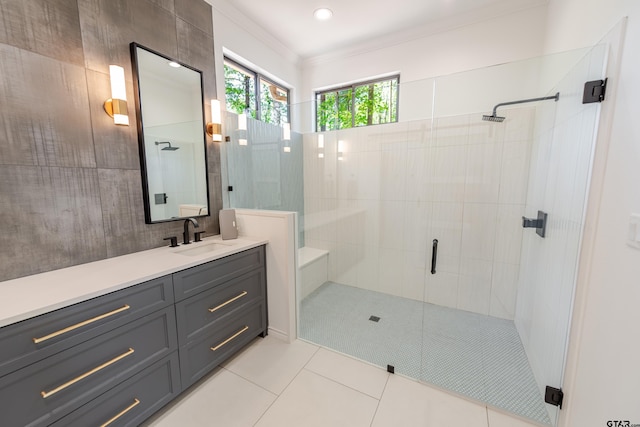 bathroom featuring crown molding, vanity, tile patterned floors, and a stall shower