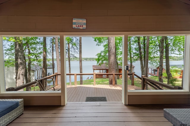 unfurnished sunroom featuring a water view