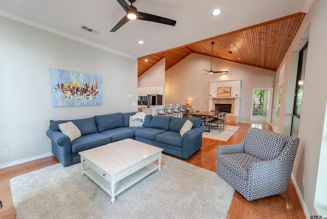 living room with baseboards, a ceiling fan, wood finished floors, and visible vents