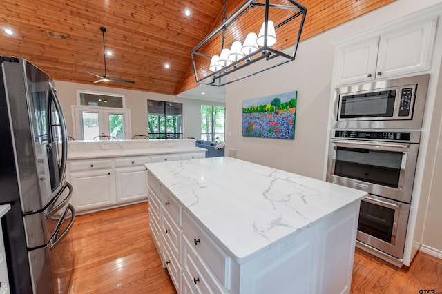 kitchen with a center island, french doors, recessed lighting, wooden ceiling, and appliances with stainless steel finishes