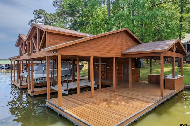 dock area featuring boat lift and a water view