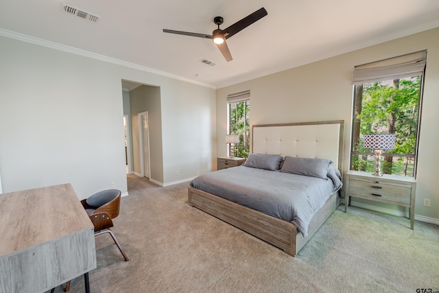 bedroom with baseboards, crown molding, multiple windows, and carpet