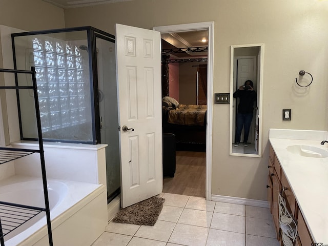 bathroom with tile patterned floors, vanity, separate shower and tub, and crown molding