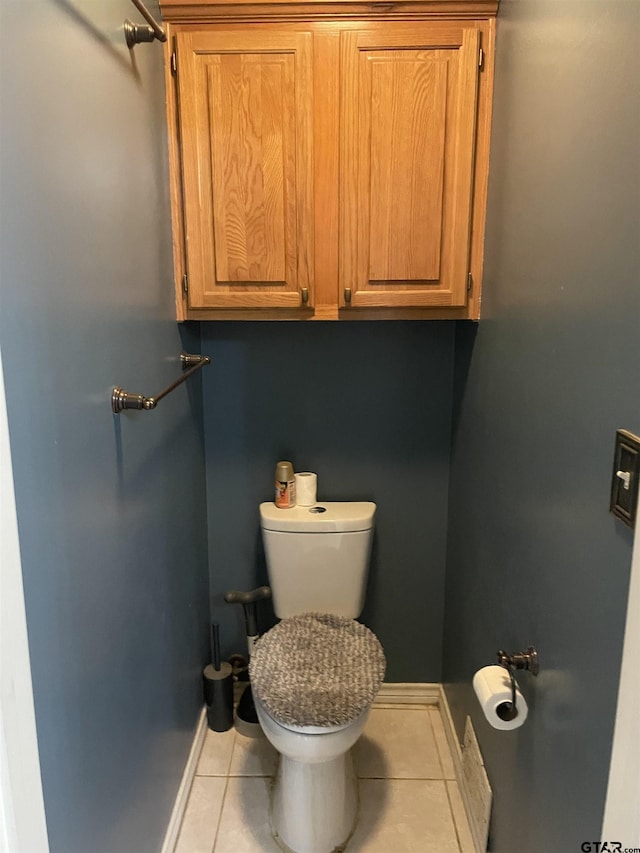 bathroom with tile patterned flooring and toilet