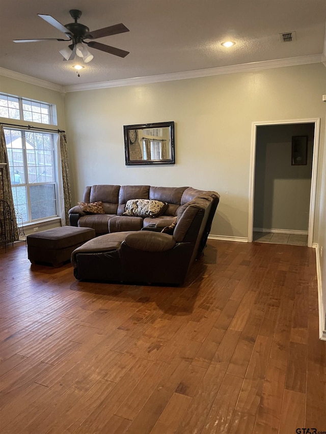 living room featuring hardwood / wood-style floors, ceiling fan, and ornamental molding