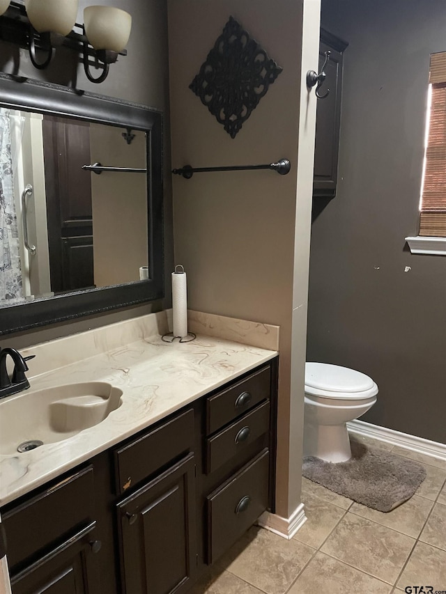 bathroom featuring tile patterned floors, vanity, and toilet