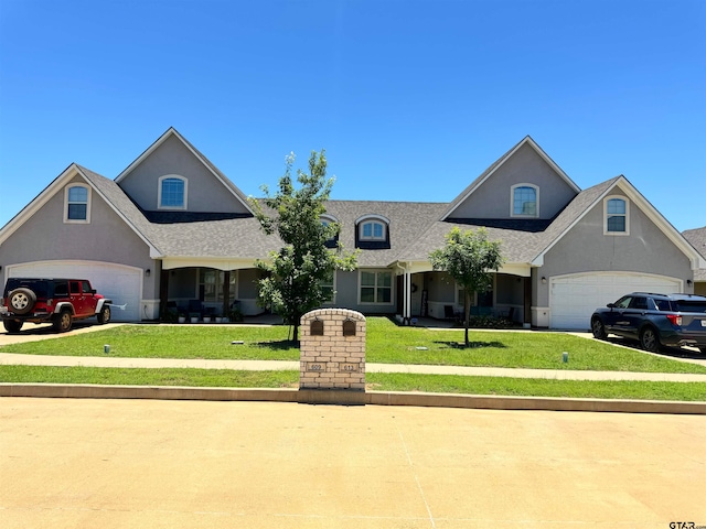 view of front of house featuring a front lawn and a garage