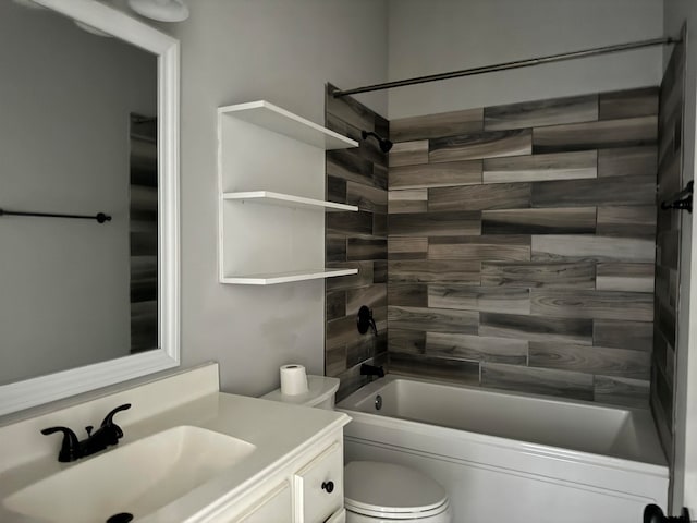 full bathroom featuring vanity, tiled shower / bath, and toilet