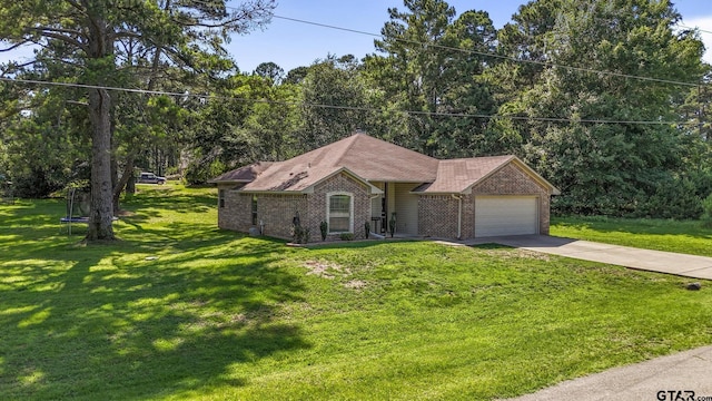 18424 Whipporwill, Flint, TX 75762 - single story home with brick siding, a garage, a trampoline, driveway, and a front lawn