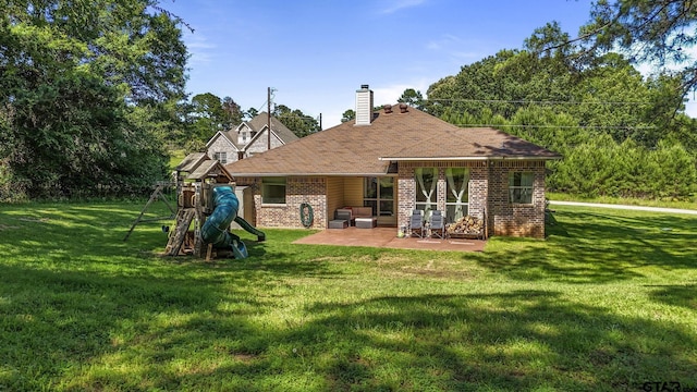 18424 Whipporwill, Flint, TX 75762 - back of house featuring brick siding, a playground, a patio, a chimney, and a lawn