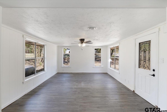 interior space with ceiling fan, dark hardwood / wood-style floors, and a textured ceiling