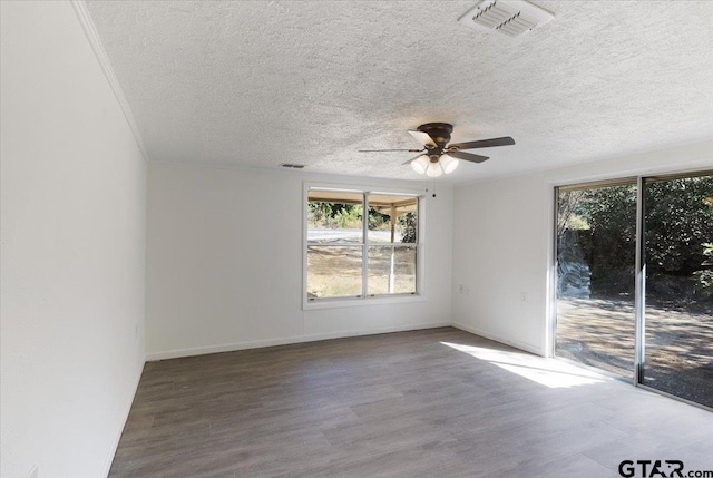 spare room featuring wood-type flooring, ceiling fan, and a textured ceiling