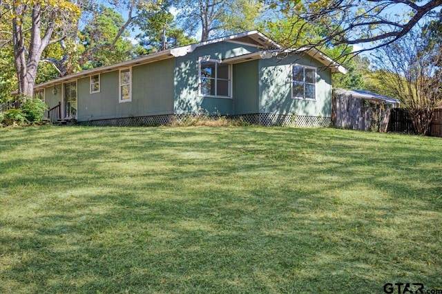 view of side of home with a lawn