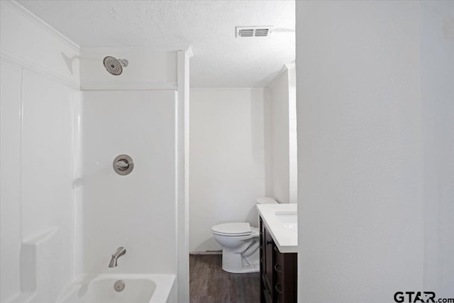 full bathroom with vanity, a textured ceiling, bathtub / shower combination, hardwood / wood-style floors, and toilet