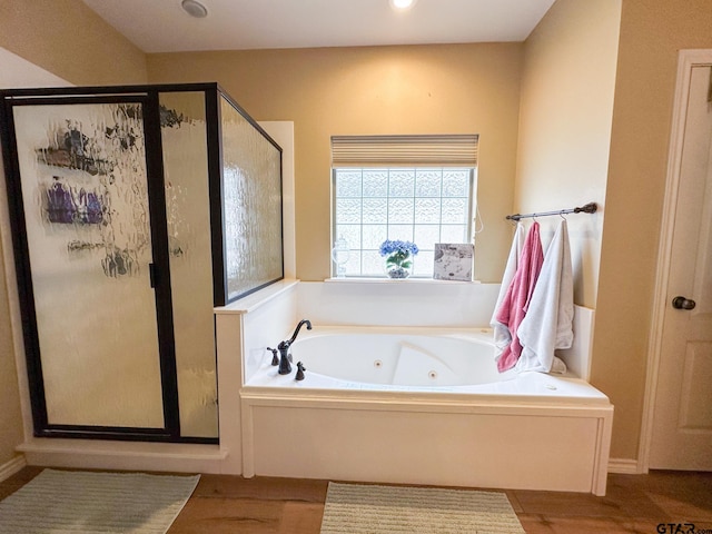 full bathroom featuring a tub with jets, a stall shower, wood finished floors, and recessed lighting
