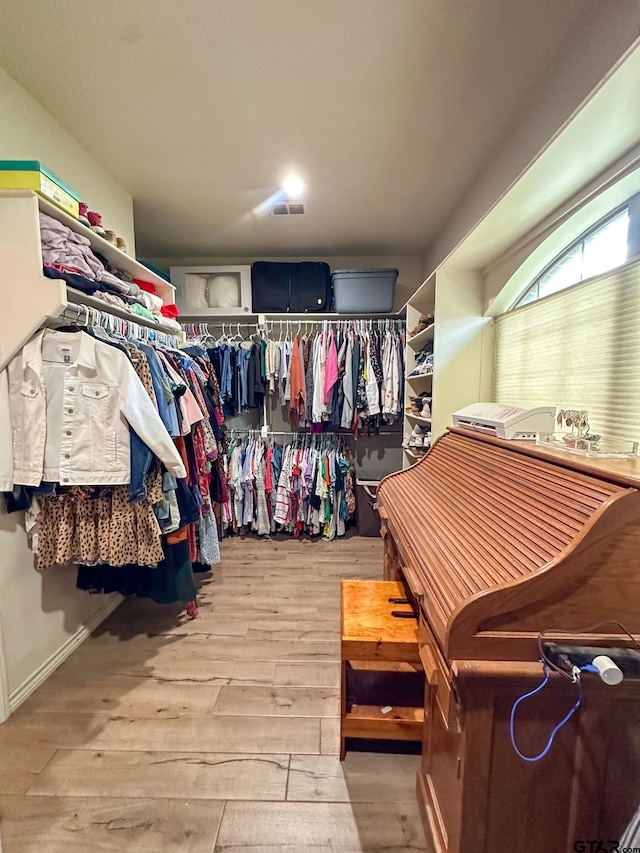 spacious closet with hardwood / wood-style flooring