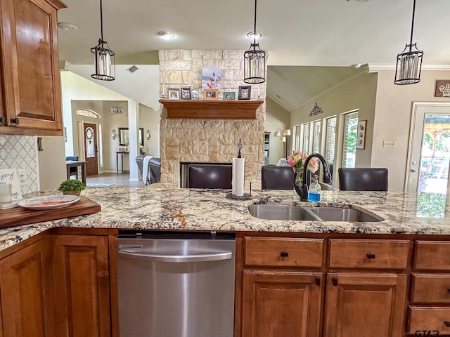 kitchen featuring dishwasher, a sink, open floor plan, crown molding, and light stone counters