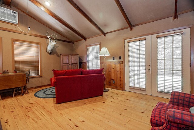 living room featuring light hardwood / wood-style floors, a healthy amount of sunlight, and french doors