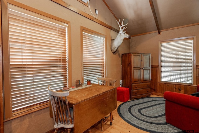 dining room with lofted ceiling with beams and wood-type flooring