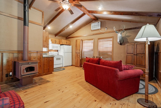 living room featuring light hardwood / wood-style floors, vaulted ceiling with beams, a wood stove, ceiling fan, and an AC wall unit