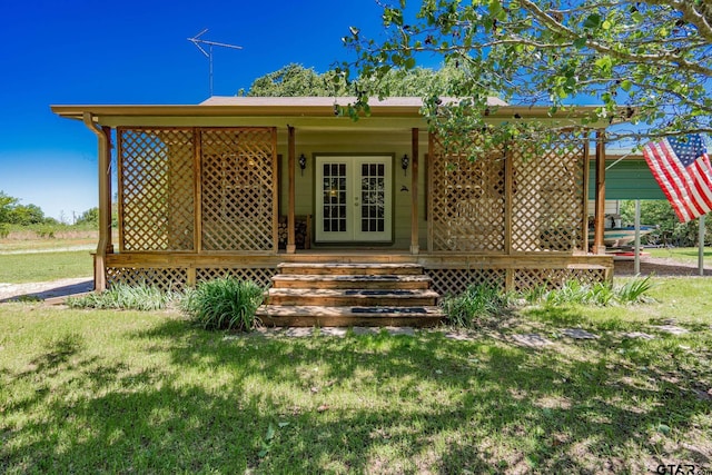 view of front of property with a front yard and french doors