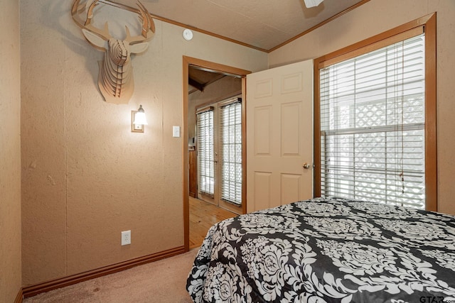 bedroom with ornamental molding, light carpet, and ceiling fan