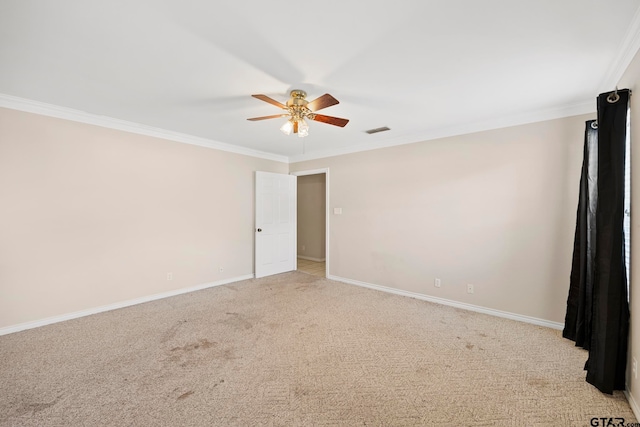 unfurnished room featuring ornamental molding, light carpet, and ceiling fan