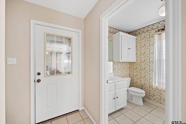 bathroom featuring vanity, tile patterned flooring, and toilet