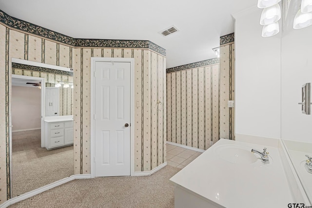 bathroom with vanity and a chandelier