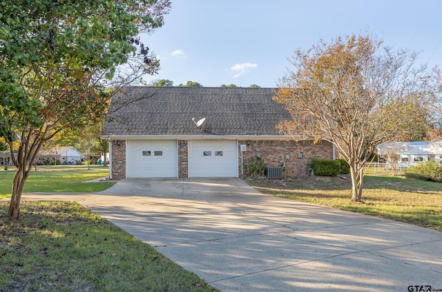 view of front of home with a front yard and central AC