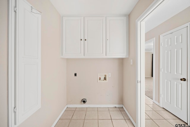 laundry area featuring hookup for an electric dryer, cabinets, hookup for a washing machine, and light tile patterned floors