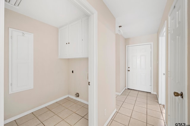 laundry room with cabinets, hookup for an electric dryer, and light tile patterned floors