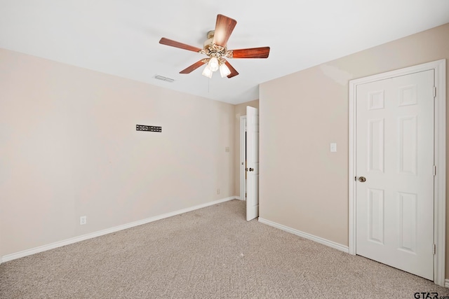 spare room with light carpet and ceiling fan