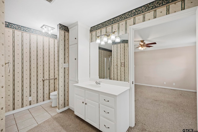 bathroom featuring ceiling fan, vanity, toilet, and tile patterned flooring