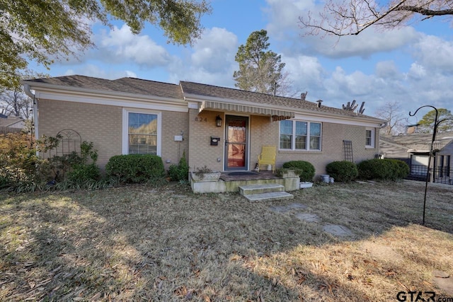 ranch-style home with a front lawn