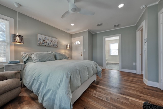 bedroom featuring crown molding, dark hardwood / wood-style flooring, connected bathroom, and ceiling fan