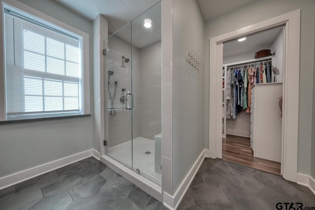 bathroom featuring a shower with door