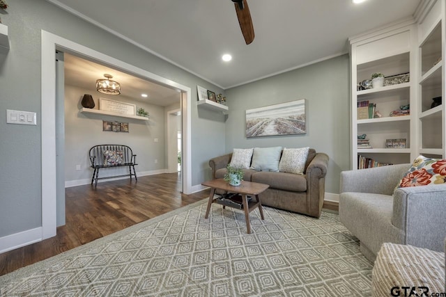 living room with hardwood / wood-style floors, ornamental molding, and ceiling fan