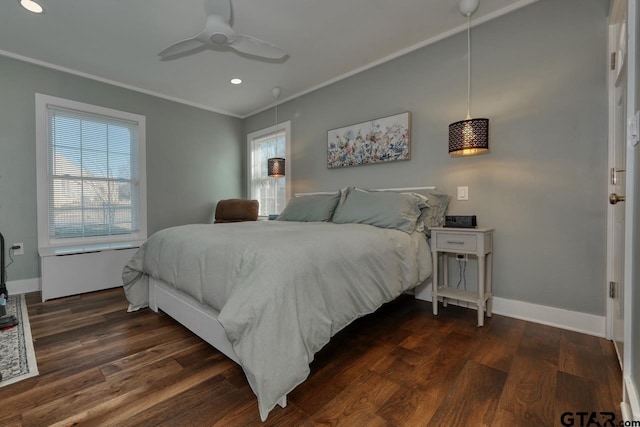 bedroom with crown molding, ceiling fan, dark wood-type flooring, and multiple windows