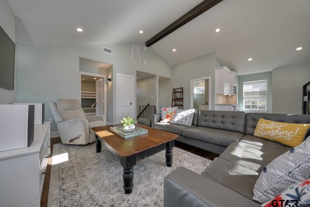 living room with lofted ceiling with beams and light hardwood / wood-style floors