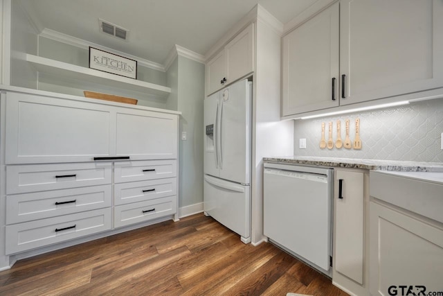 kitchen featuring white cabinets, white refrigerator with ice dispenser, dishwashing machine, and dark hardwood / wood-style flooring