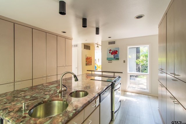 kitchen with stainless steel dishwasher, cream cabinets, light stone counters, and electric range