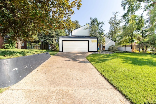 view of front of home featuring a garage and a front lawn