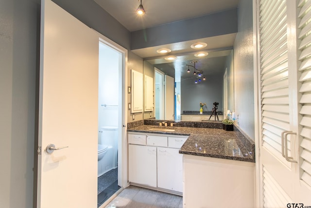 bathroom featuring hardwood / wood-style floors, vanity, and toilet