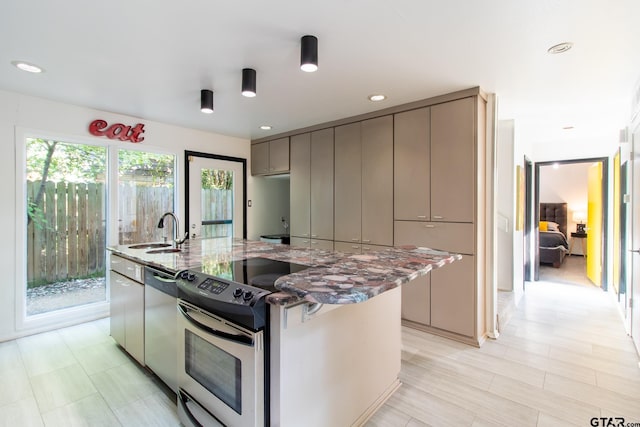 kitchen with dark stone counters, dishwasher, sink, gray cabinetry, and range with electric stovetop