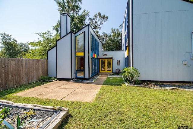 view of outbuilding featuring a lawn and french doors