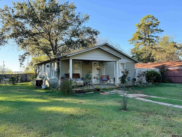 bungalow-style house with a front yard and a porch