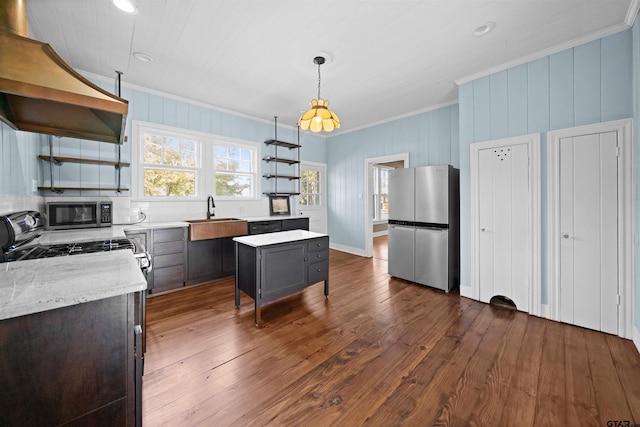 kitchen featuring dark wood-type flooring, decorative light fixtures, a kitchen island, custom range hood, and appliances with stainless steel finishes