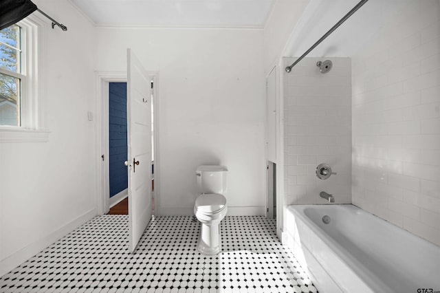 bathroom with tiled shower / bath combo, toilet, and crown molding